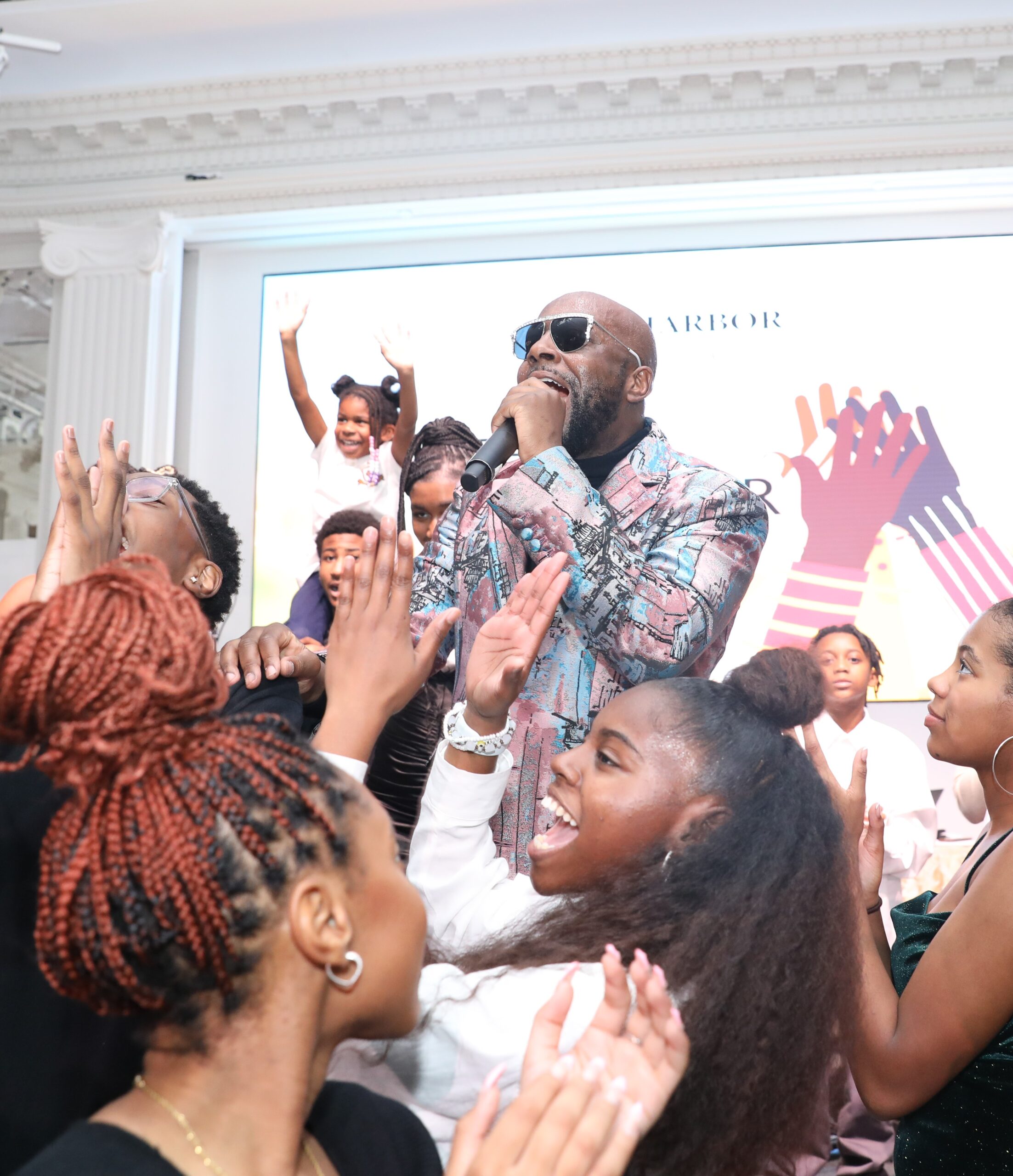 Wyclef Jean performs with SCAN-Harbor Performing Arts Academy students at the Better Together Gala 2022