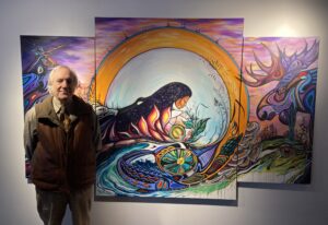 SCAN-Harbor Executive Director, Lew Zuchman, stands with Indigenous Artwork at Bay College in Michigan
